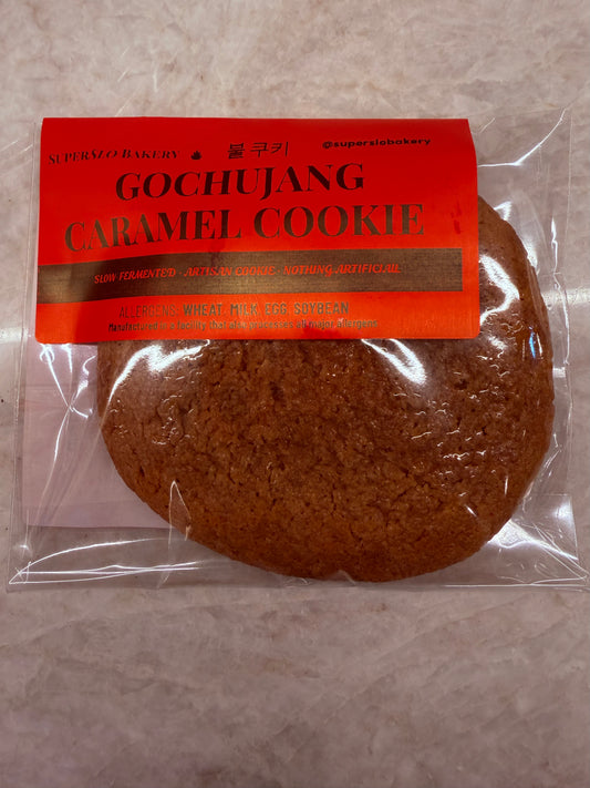Gochujang caramel cookie from My Store showing a close-up of a baked cookie with a glossy caramel glaze and a hint of red gochujang.