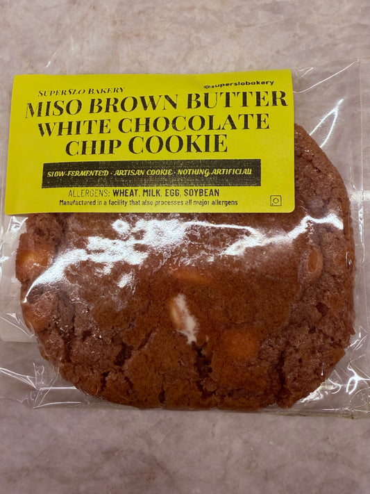 Miso Brown Butter White Chocolate Chip Cookie by SuperSlo Bakery, close-up of a freshly baked cookie with white chocolate chips
